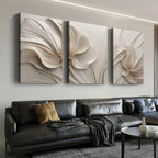Modern living room with a black sofa and decorative wall art.