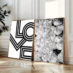 Two framed artworks, one geometric and one floral, on a wall.