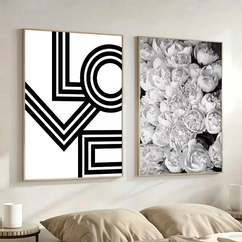 Two framed artworks on a wall, one with geometric design and the other with floral pattern.