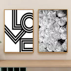 Two framed artworks on a wall, one with 'LOVE' design and the other with floral pattern.