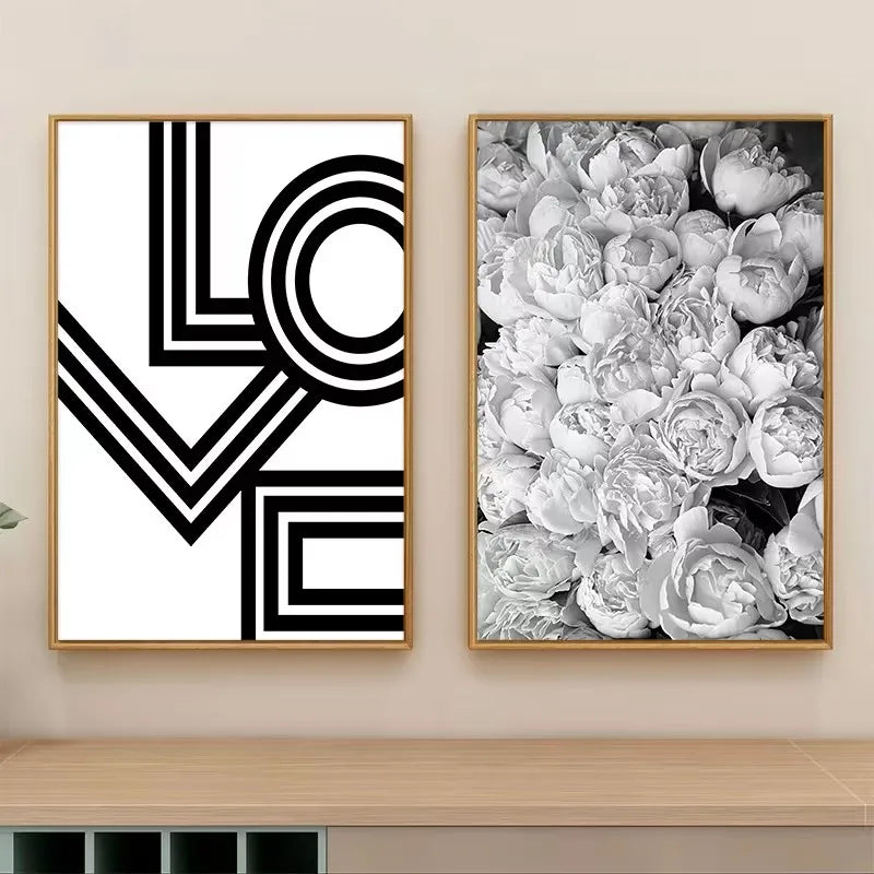 Two framed artworks on a wall, one with 'LOVE' design and the other with floral pattern.