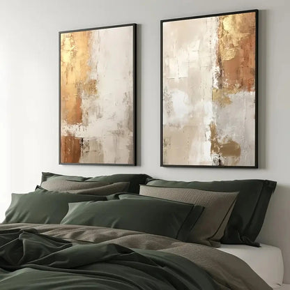 Two abstract art pieces on a wall above a bed with green bedding.