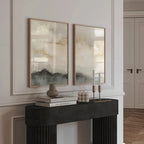 Decorative setup on a mantelpiece with framed artwork, books, and candles.