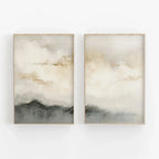 Two abstract wall art pieces with cloud and mountain designs in neutral tones on a white background.