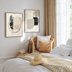 Cozy bedroom with abstract art, wicker chair, and straw hat on bed