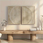 Wooden table with decorative items against a wall with two framed artworks.