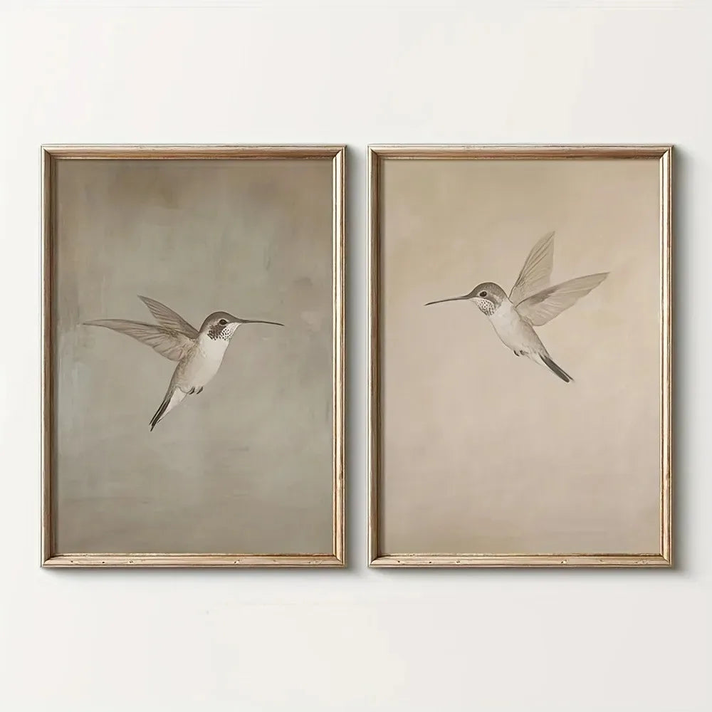 Two framed prints of hummingbirds on a white wall