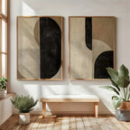Two abstract art pieces on a wall with a wooden bench and plants in a room.