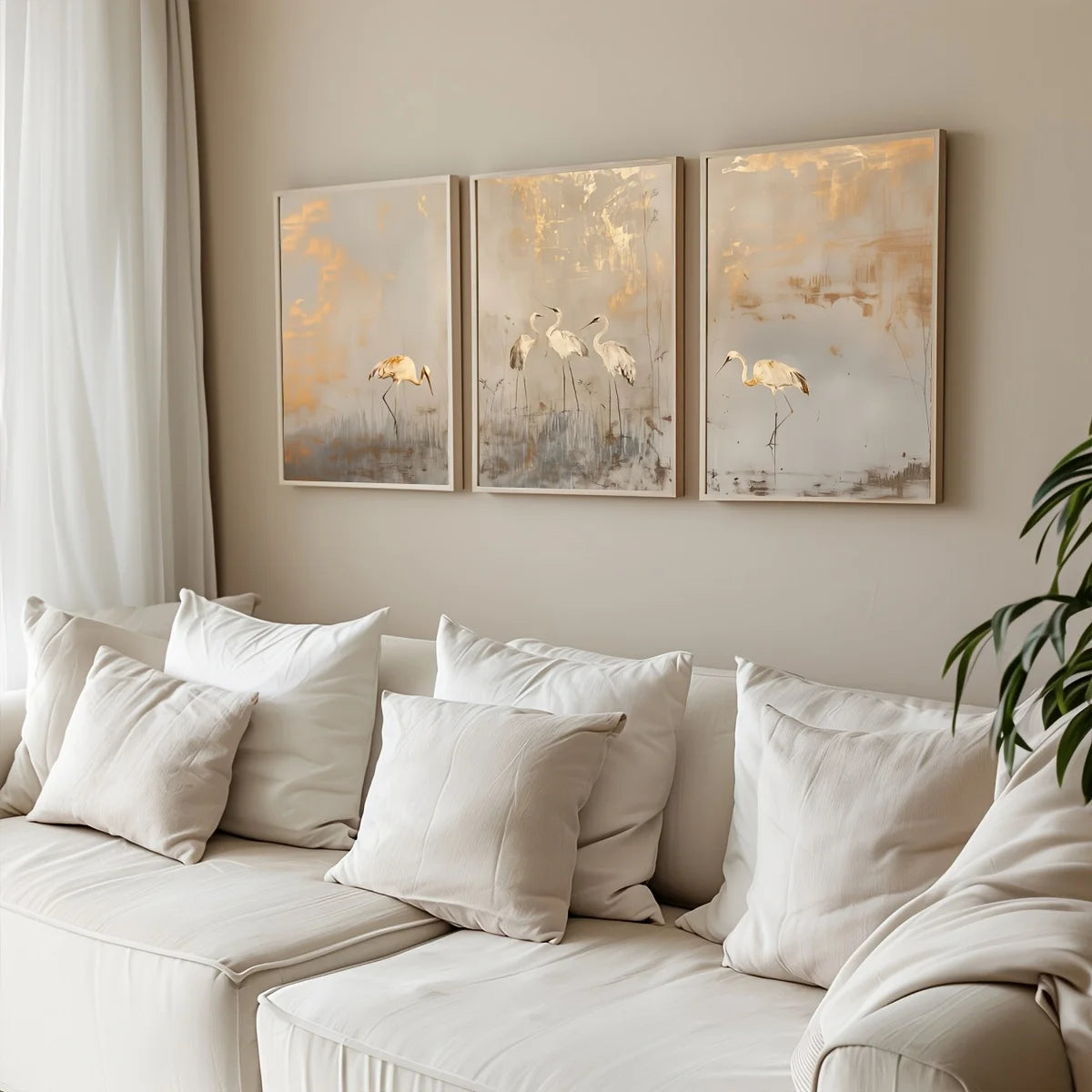 White sofa with decorative pillows in a living room with wall art of birds.