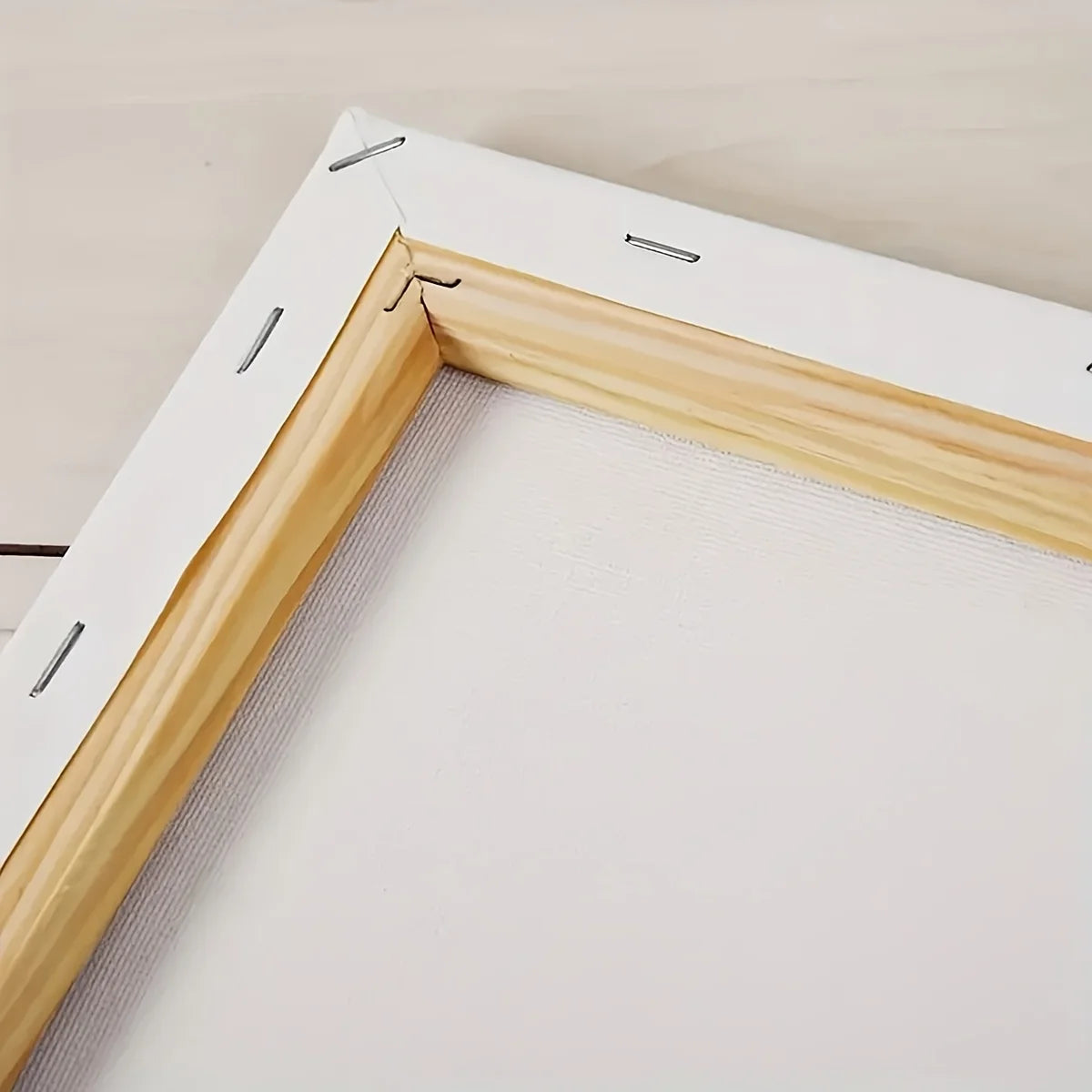 Close-up of a wooden picture frame with a white mat on a beige background