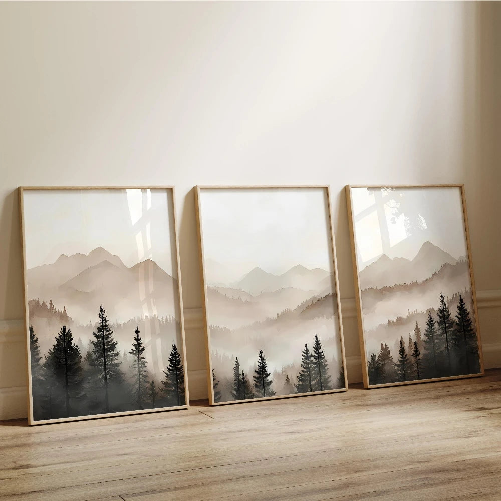 Three framed landscape paintings of mountains and trees on a wall.