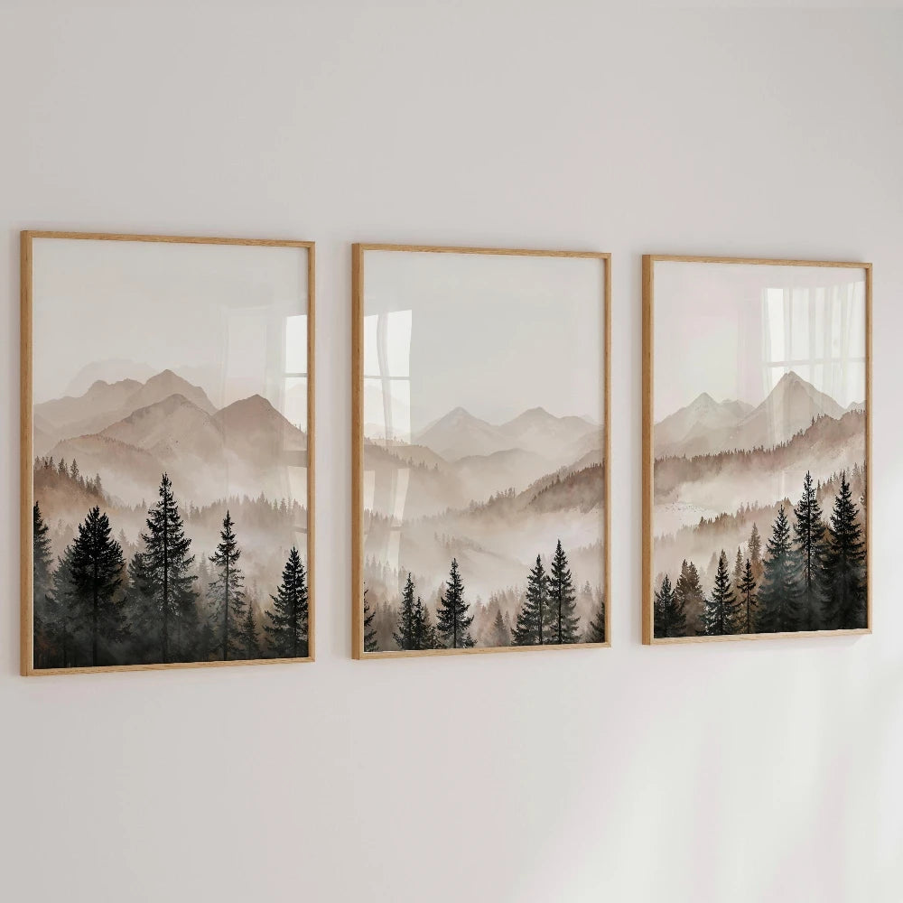 Three framed landscape paintings of mountains and trees on a wall.