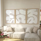 Living room with a gray sectional sofa and abstract wall art