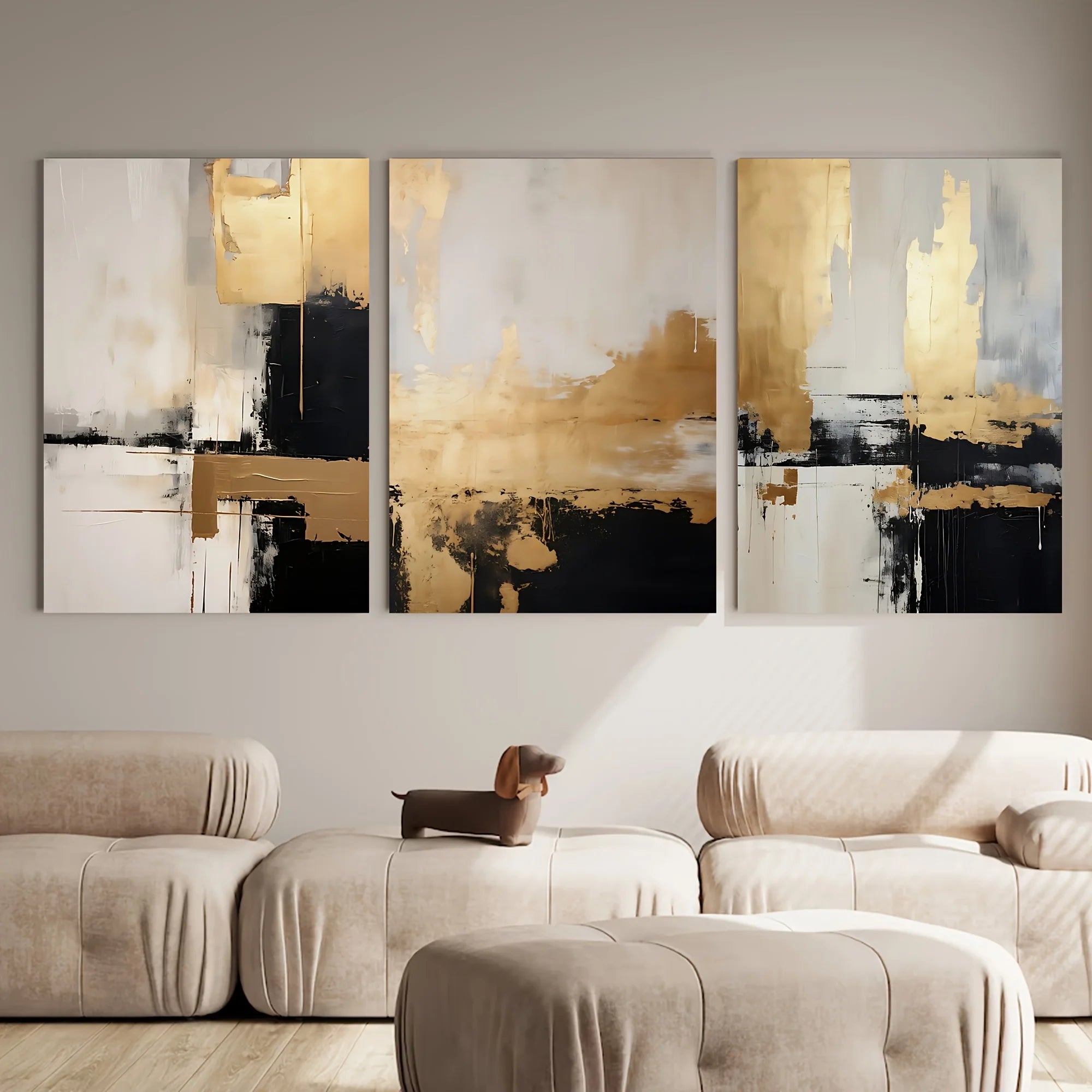 Set of abstract art paintings in a living room setting with a dog on a sofa.