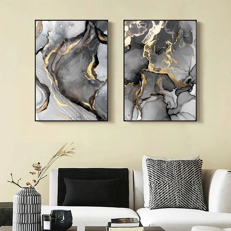 Two abstract art pieces with gold accents on a wall above a sofa.
