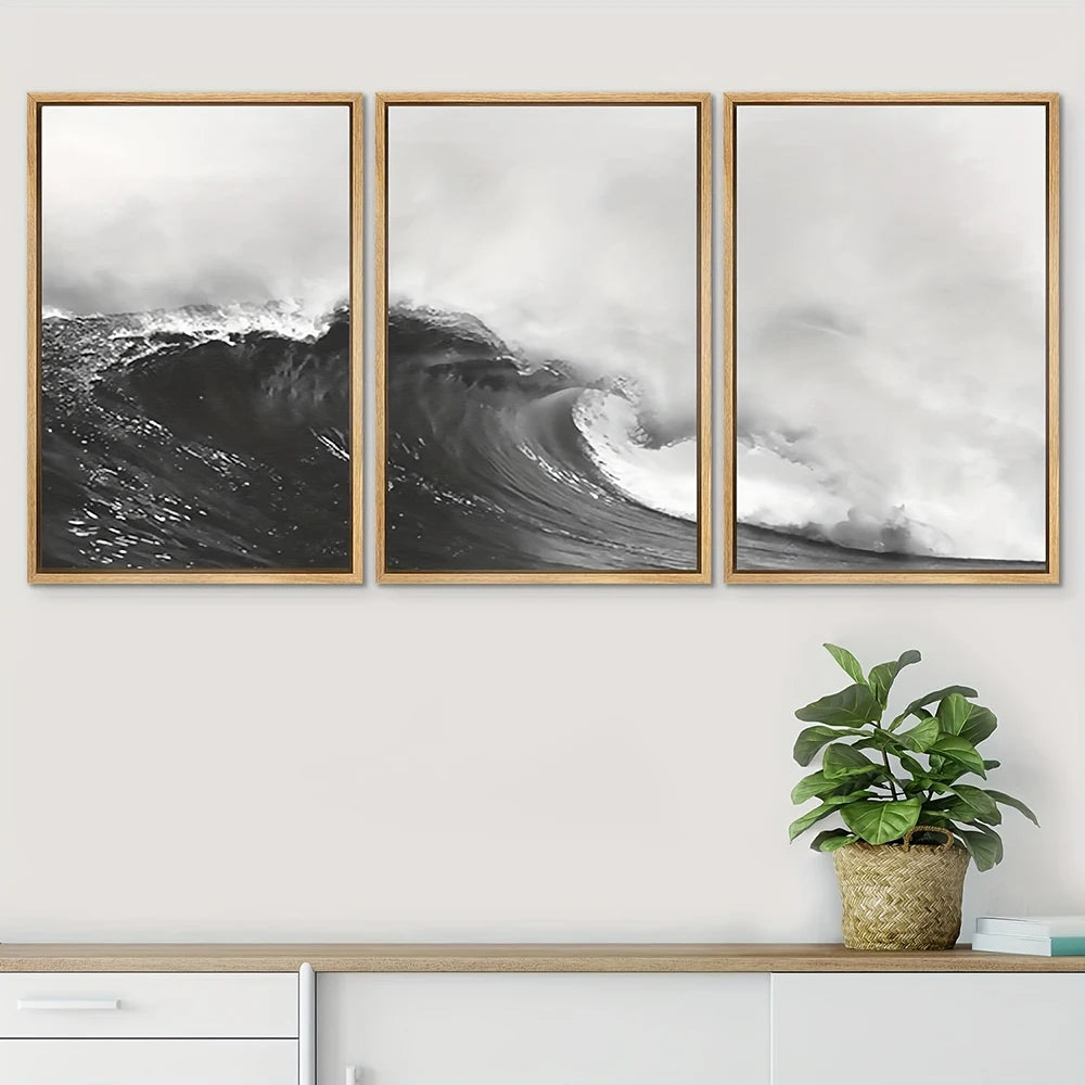 Three framed prints of ocean waves on a wall with a plant below.