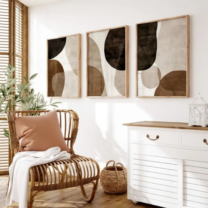 Living room with wicker chair, white dresser, and abstract wall art