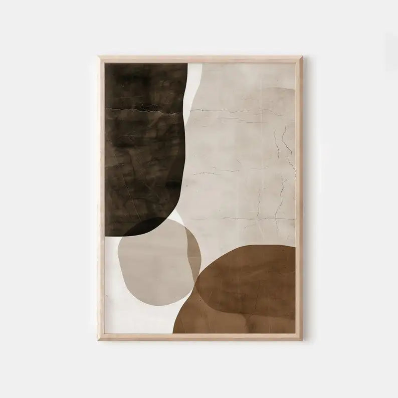Abstract art print with brown and beige shapes in a wooden frame on a white wall.
