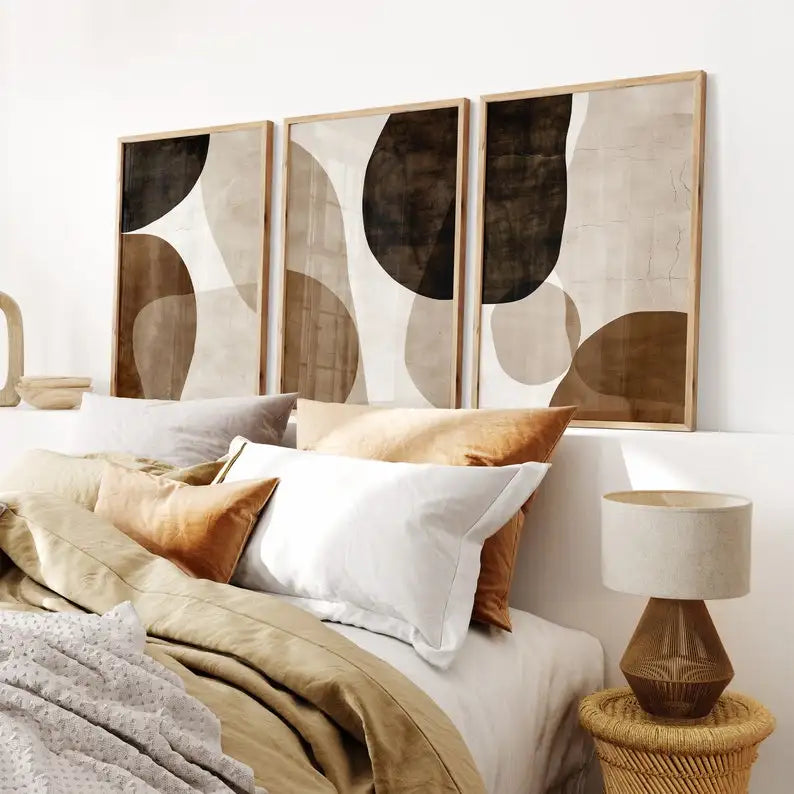Bedroom with abstract wall art, pillows, and a lamp.