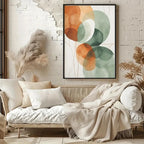 Cozy living room with a wicker sofa, decorative pillows, and a colorful abstract painting on a brick wall.