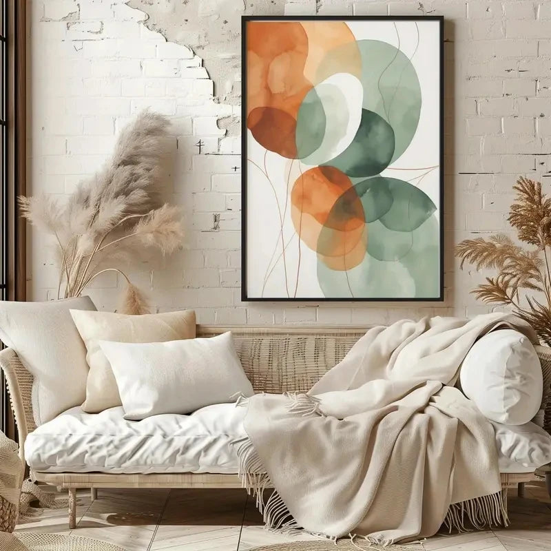 Cozy living room with a wicker sofa, decorative pillows, and a colorful abstract painting on a brick wall.