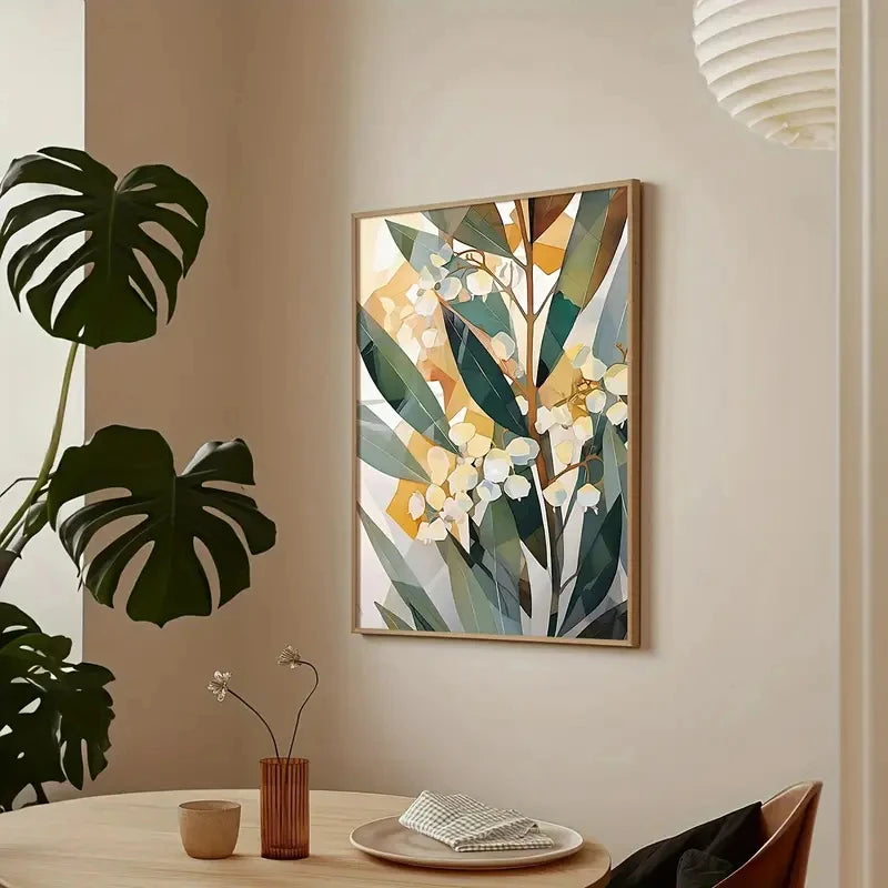 Framed botanical art on a wall with a plant and table setting in the foreground.