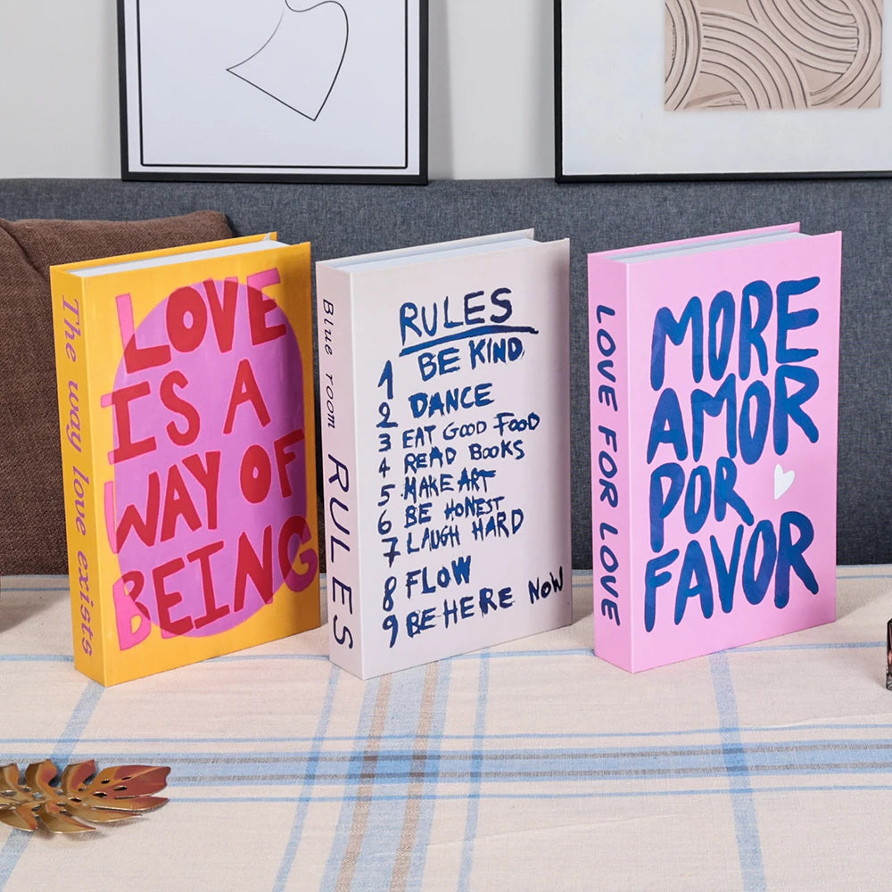 Three colorful books with motivational text on a surface with a neutral background