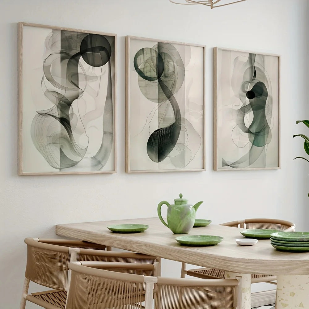 Dining room with abstract art on the wall and a wooden table with green dishes and a teapot.