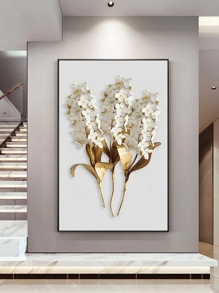 Decorative wall art of white flowers with gold accents in a modern interior setting.