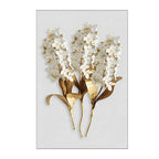 Decorative wall art with gold and white floral design on a light gray background