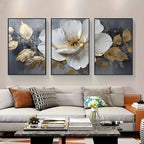 Three floral art pieces above a sofa in a living room setting.