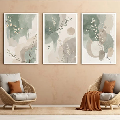 Three abstract art prints on a wall above two wicker chairs with cushions.