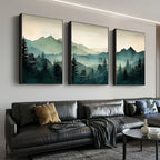 Three landscape paintings of mountains and trees on a wall above a sofa.