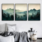 Three framed landscape paintings of mountains and trees on a wall above a sofa.