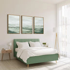 Green bed in a bright bedroom with white walls and large windows.