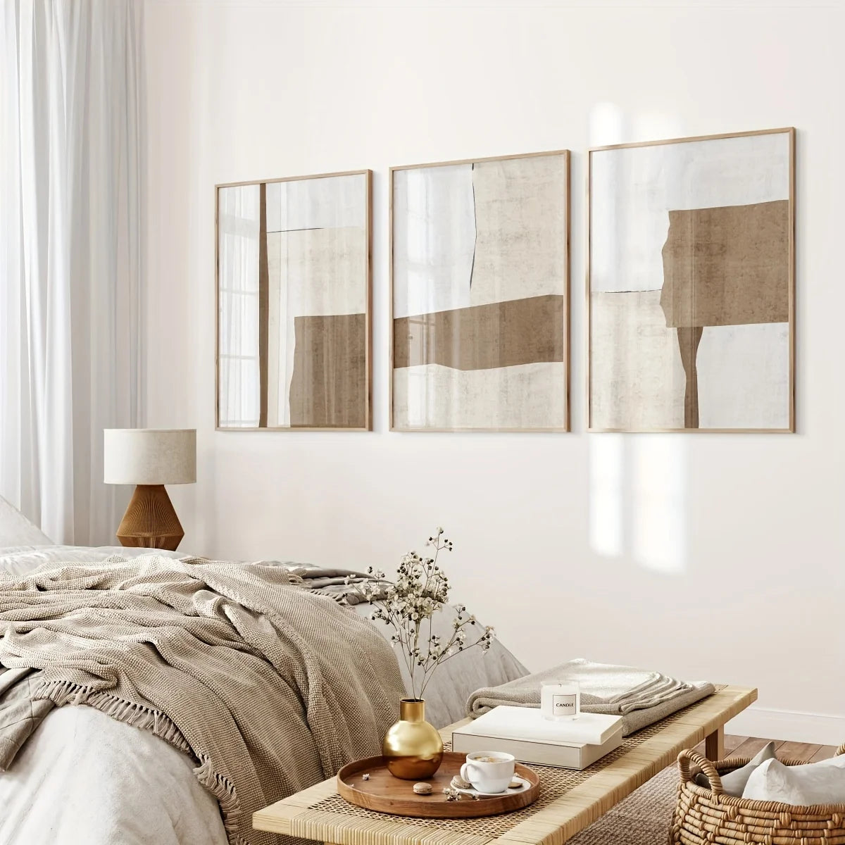 Neatly arranged bedroom with abstract wall art, a lamp, and a small table with a cup.
