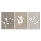 Three abstract wall art pieces with white leaf-like shapes on a beige background