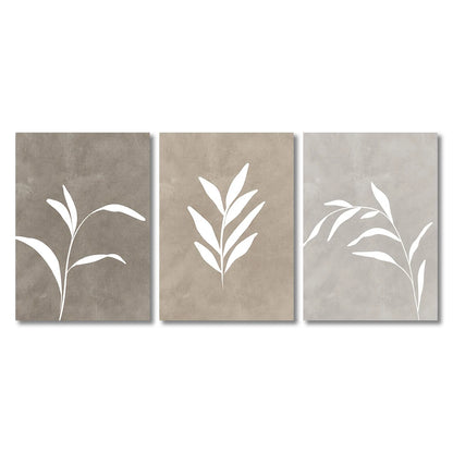 Three abstract wall art pieces with white leaf-like shapes on a beige background