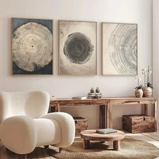 Living room with a white armchair, wooden coffee table, and wall art depicting tree rings.