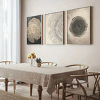 Dining room with a table and chairs, featuring three circular wall art pieces on the wall.