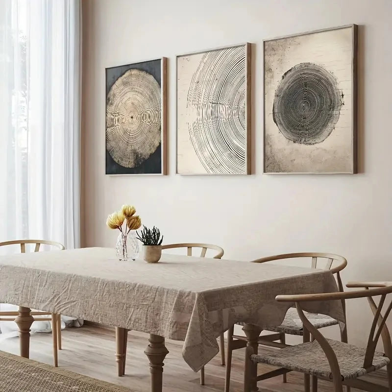 Dining room with a table and chairs, featuring three circular wall art pieces on the wall.