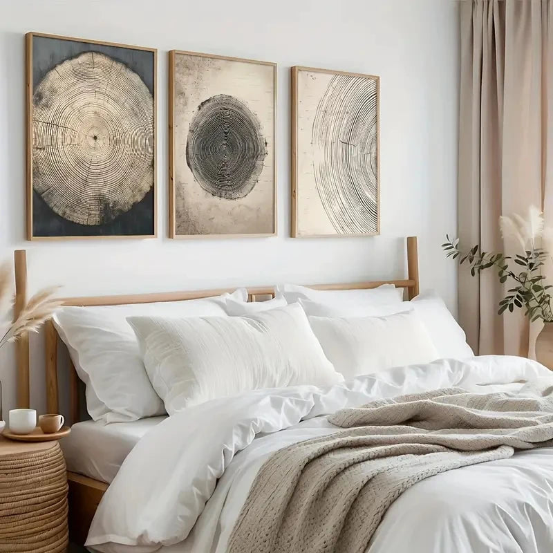 Bedroom with white bedding, wooden headboard, and wall art depicting tree rings.