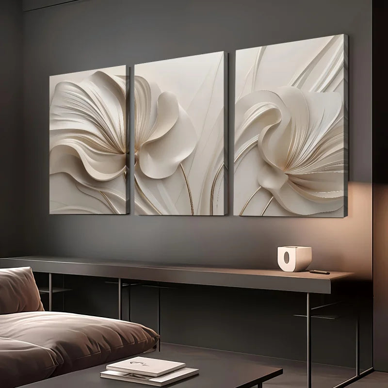 Three abstract wall art pieces on a dark wall above a modern console table.
