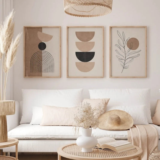 Living room with a white sofa, decorative pillows, and framed abstract art on the wall.
