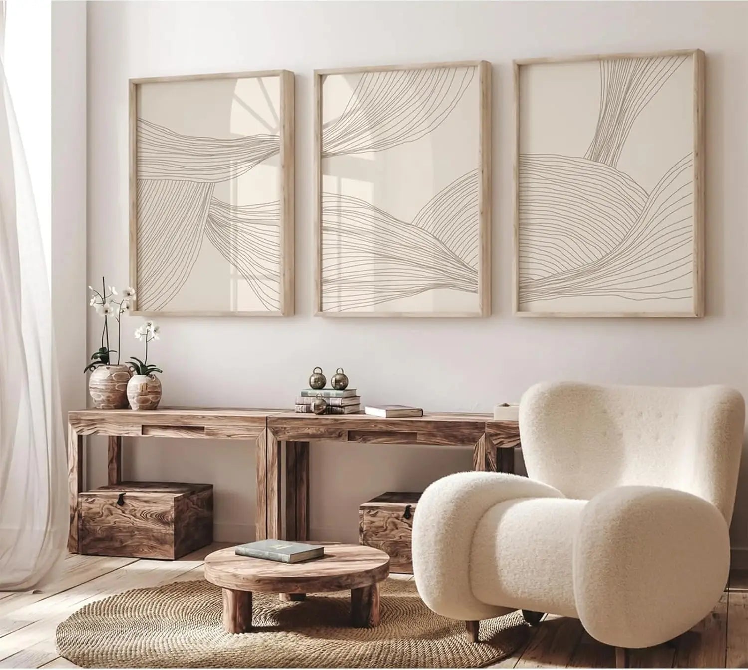 Modern living room with a wooden console table, cream armchair, and abstract wall art.