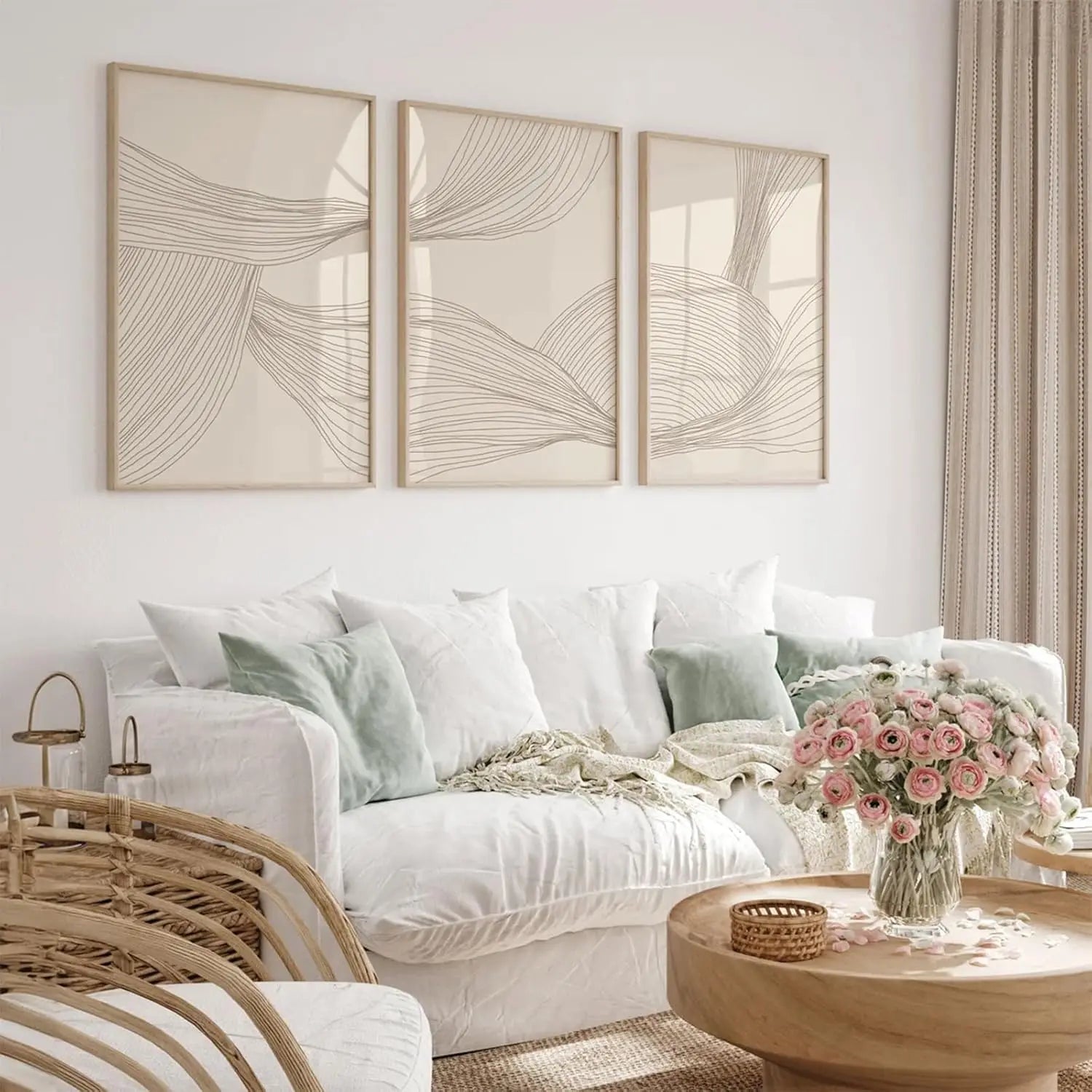 Living room with a white sofa, wicker chair, and floral arrangement on a wooden table.
