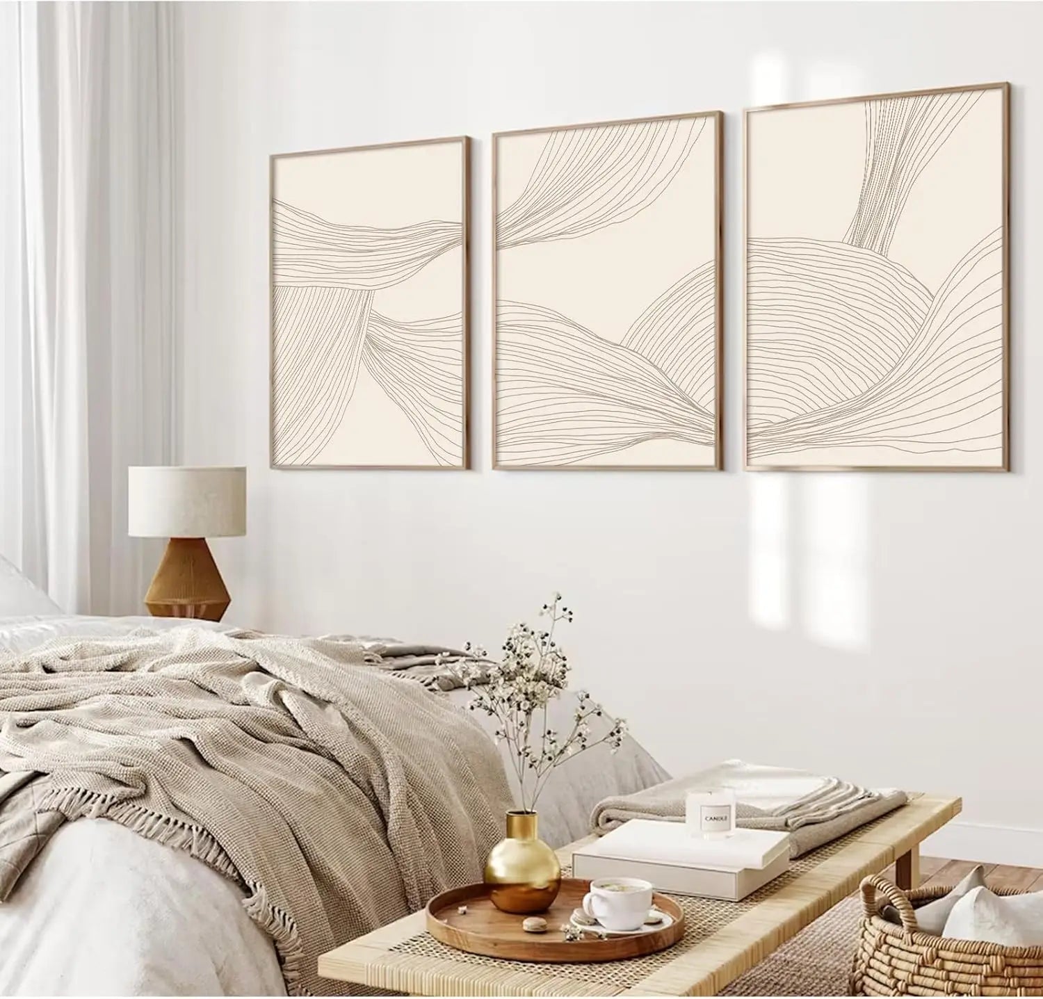 Three abstract wall art pieces above a bed in a bedroom setting.