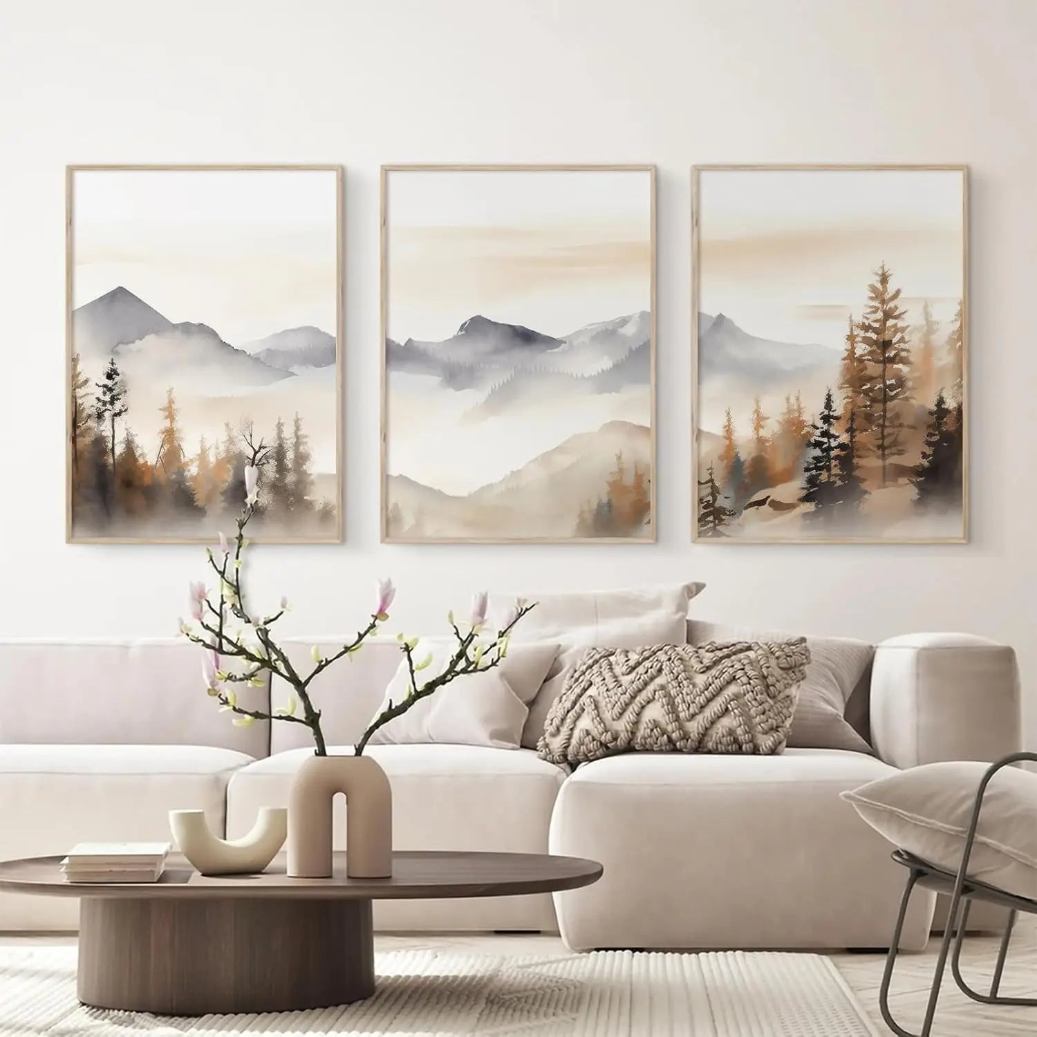 Living room with a beige sofa, wooden coffee table, and three framed landscape paintings on the wall.