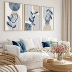 Living room with a white sofa, wicker chair, and abstract wall art.