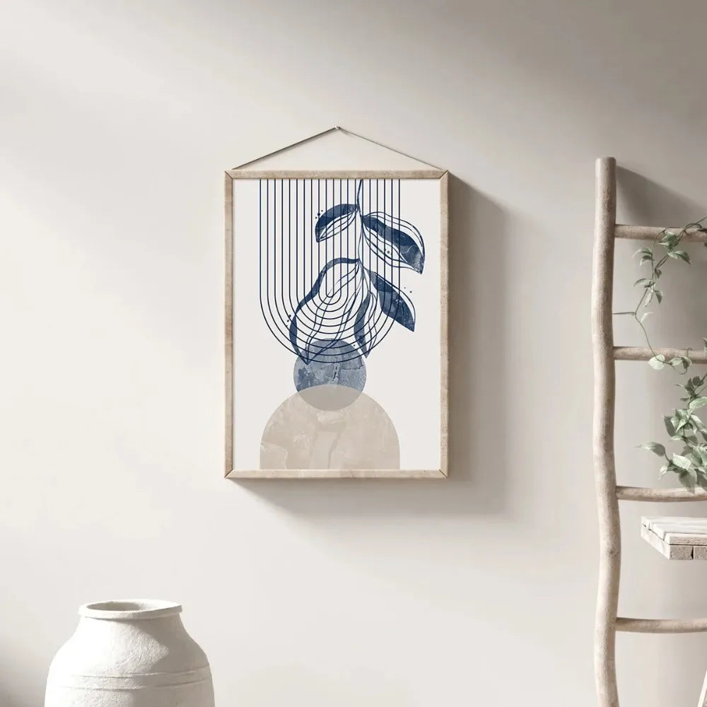 Framed abstract art piece on a wall with a ladder and plant in the background